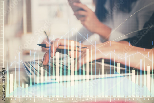 Multi exposure of woman hands typing on computer and financial graph hologram drawing. Stock market analysis concept.