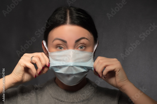 Healthy woman using medical protective mask to health protection