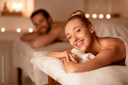 Happy Lady Relaxing At Spa With Husband, Smiling Enjoying Aromatherapy