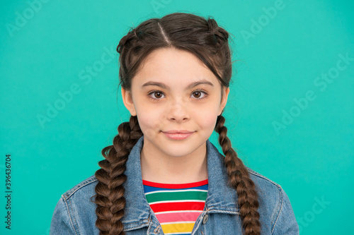 Εκτύπωση καμβά Beautiful girl child with cute look wear long hair plaits blue background, beaut