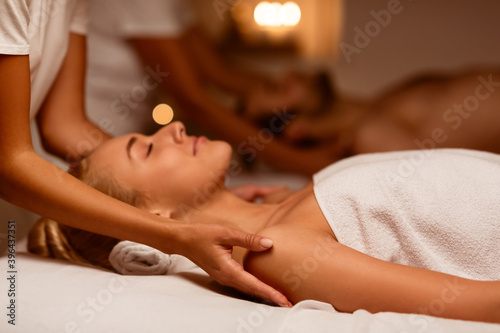 Wife And Husband Enjoying Relaxing Massage Lying At Luxury Spa