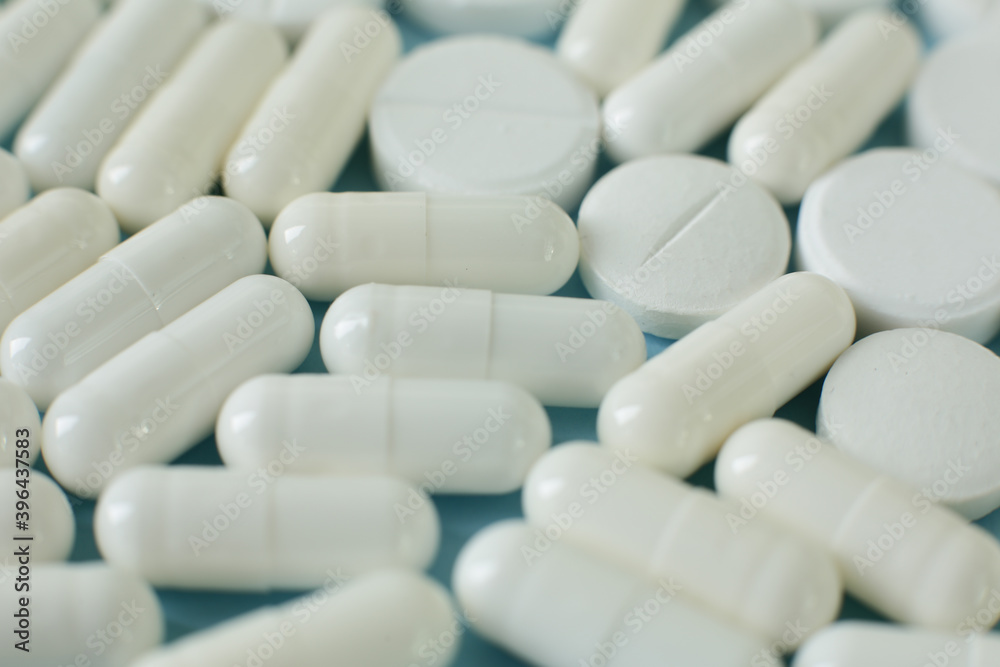 White pills on blue background White pills on blue background