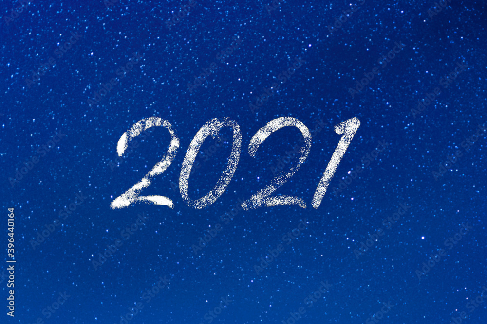 2021 year. 2021 text on a blue starry background at night. Concept of aspirations, dreams, magic, wishes, stars, universe. Banner, wallpaper, poster, billboard or greeting card with space for text.
