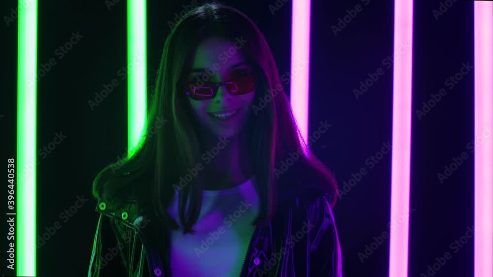 Portrait of a pretty young beautiful woman looking at the camera over sunglasses and shows an OK gesture. Close up. Slow motion. Portrait of a pretty young beautiful woman looking at the camera over sunglasses and shows an OK gesture. Close up. Slow motion.