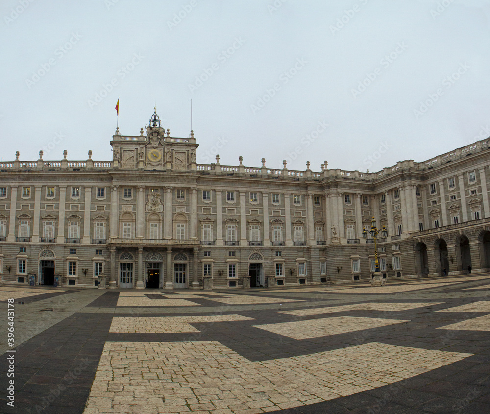 Heritage. Monumental architecture and design. Panorama view of the empty Royal Palace of Madrid baroque facade, square and floor made with blocks in Madrid, Spain. 