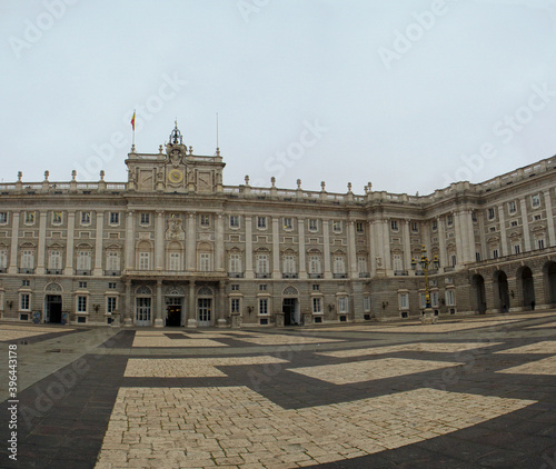 Heritage. Monumental architecture and design. Panorama view of the empty Royal Palace of Madrid baroque facade, square and floor made with blocks in Madrid, Spain. 