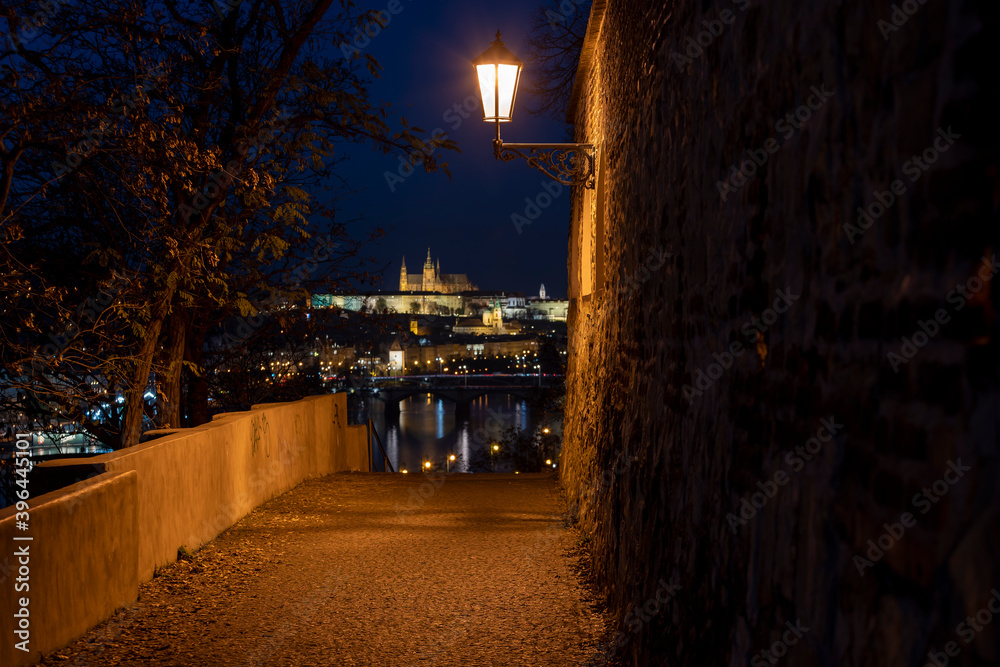 
timelapse illuminated prague castle and saint vitus church. view through the old illuminated castle fortress from the 17th century flowing river Vltavaat night in the center of Prague in Czech 
