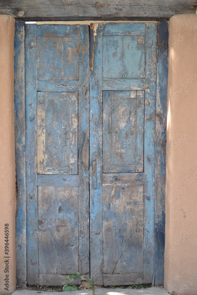 Blue wooden door in Santa Fe, New Mexico on an Adobe house. Blue wooden door in Santa Fe, New Mexico on an Adobe house.