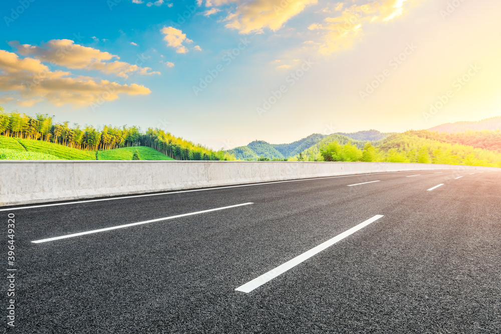 Naklejka premium Country asphalt road and green tea plantation with bamboo forest natural landscape.