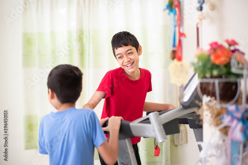 Teen boy running on treadmill for exercise