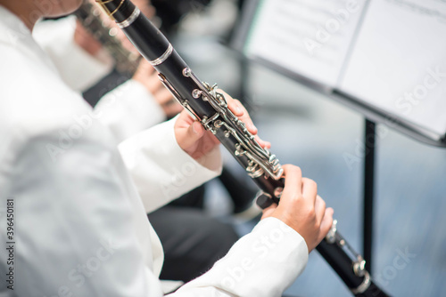 Girl on clairinet player perfomance on stage wind symphony