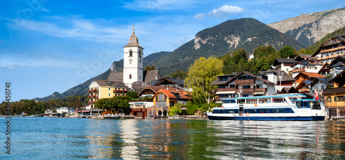Panoramic view from the Wolfgangsee to the village St. Wolfgang with the mountains in the background photo