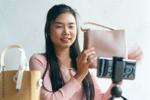 Woman holding Bag in front of camera For Livesteam sale online shopping