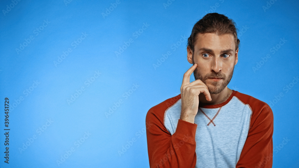 thoughtful man looking away on blue background thoughtful man looking away on blue background