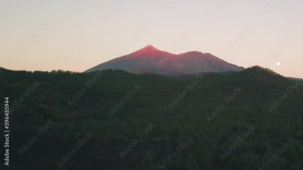 El Teide located in Tenerife glowing during a golden sunset. El Teide located in Tenerife glowing during a golden sunset.