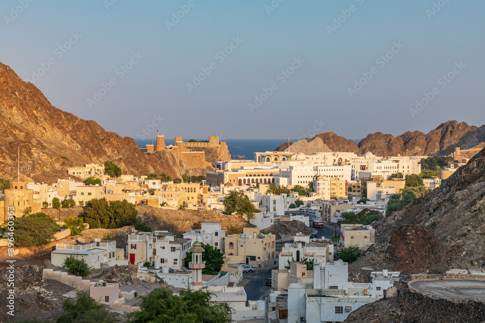 Middle East, Arabian Peninsula, Oman, Muscat. Sunset view of a neighborhood in the hills of Muscat.