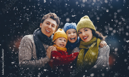 Portrait of loving family on dark snowy background