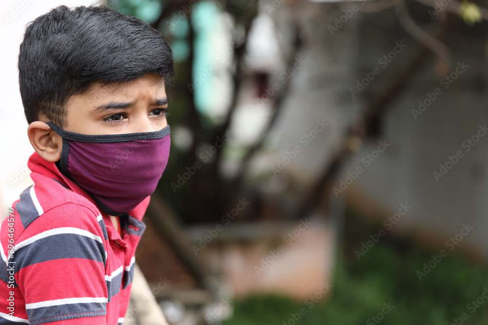 Portrait of young Indian boy wearing protective mask against the coronavirus
Portrait of young Indian boy wearing protective mask against the coronavirus