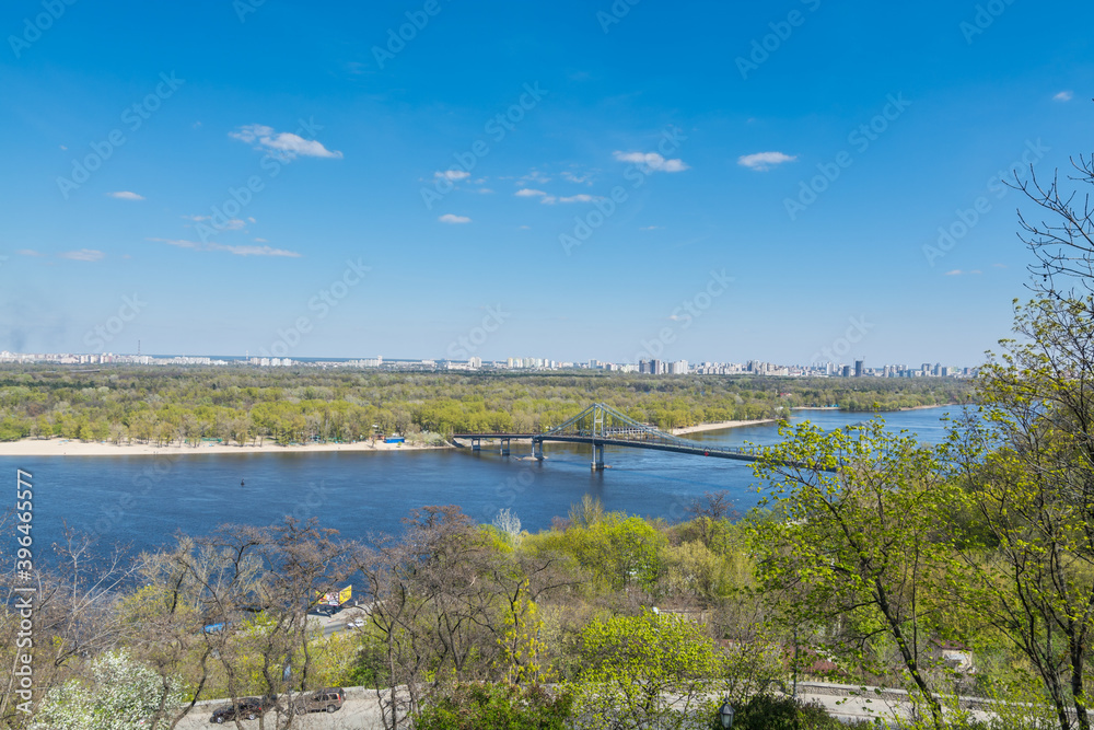 Fototapeta premium Landscape of riverbank and River of Dnieper against blue sky, view from the The Volodymyrska hill