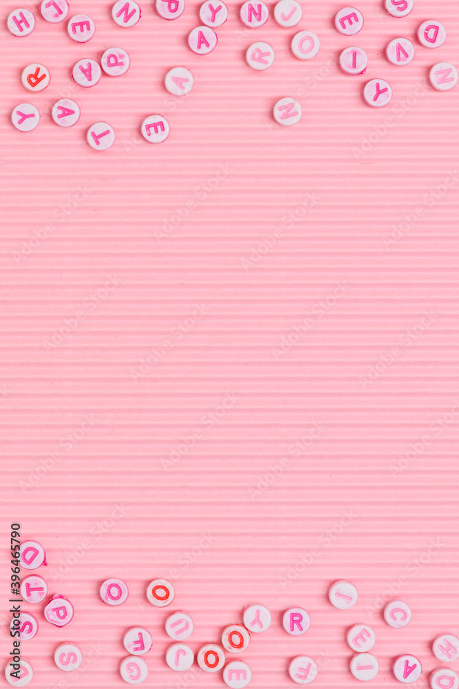 Alphabet beads border pink background