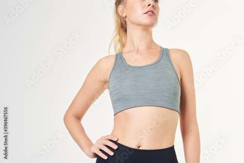 Fotografie Blonde woman in a gray sports bra mockup