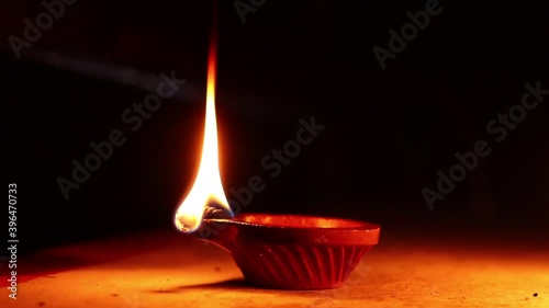 Clay Diya or Oil Lamps lit during the Diwali night. Close up of illuminating diya, clay lamp during celebration of Indian festival Diwali photo