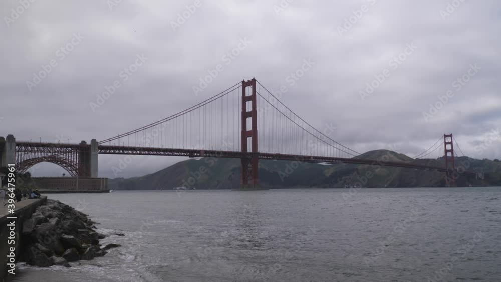 Golden Gate Bridge in San Francisco California on dark overcast cloudy day, Pan right reveal shot Golden Gate Bridge in San Francisco California on dark overcast cloudy day, Pan right reveal shot