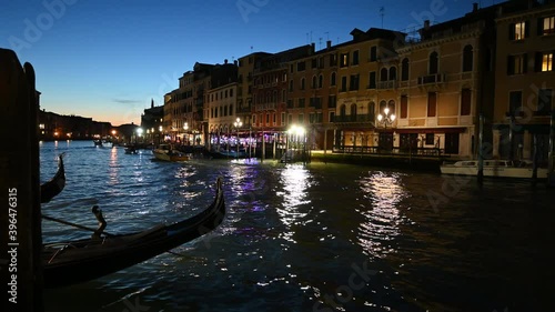 
Venice, Italy - November 2020 - The Rialto bridge and the Grand Canal light up at sunset with a thousand colors and reflections