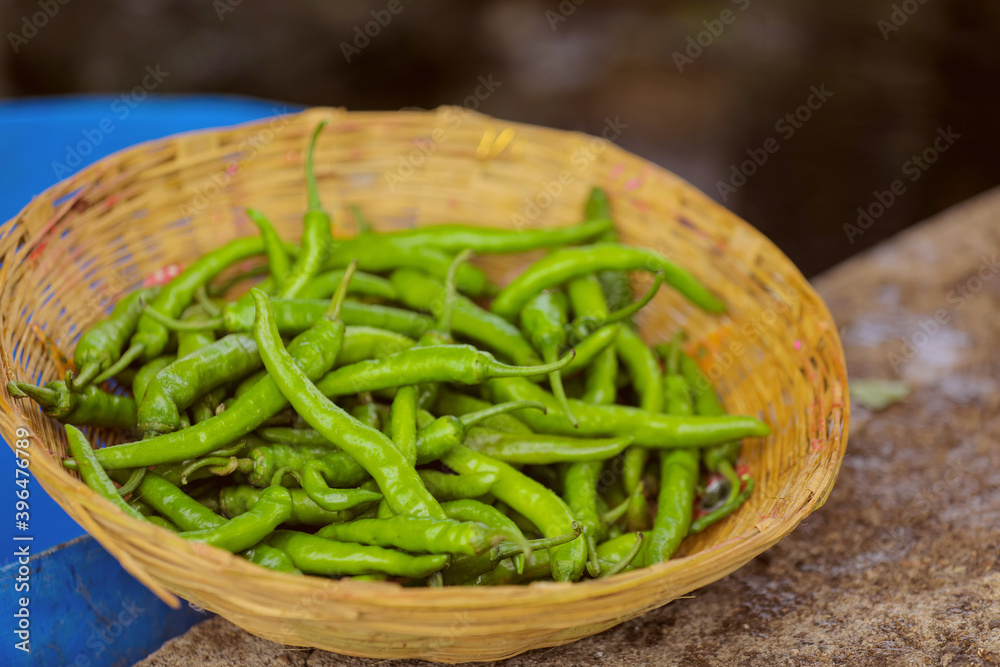 Fresh green chilly in wooden bowl Fresh green chilly in wooden bowl