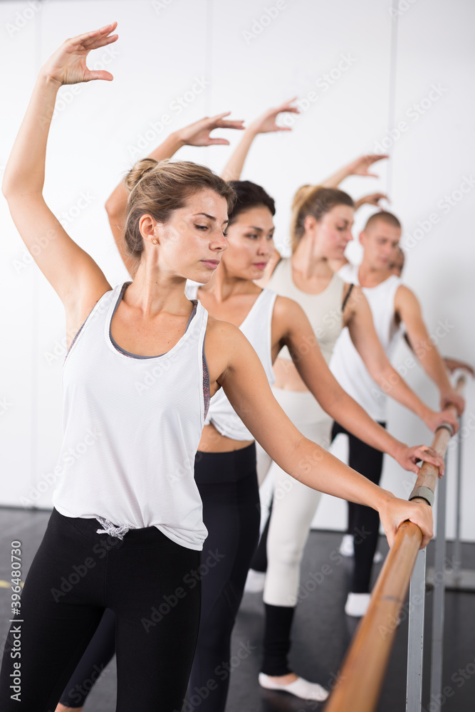 Fototapeta premium Warm-up sessions at the bench, women and men doing ballet