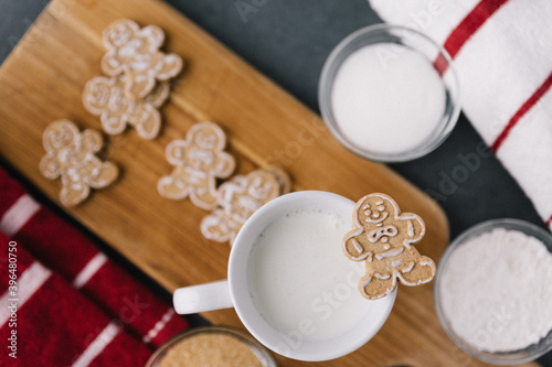 Christmas Holiday Ginger Bread Man Cookie On Mug Of Milk With Cookies And Baking Material