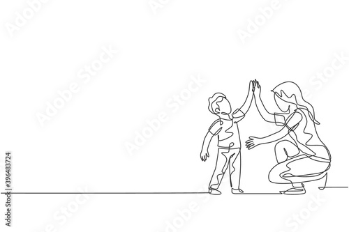 One single line drawing of young mother giving high five to her son for a success achievement, parenting vector illustration. Happy family playing together concept. Modern continuous line draw design