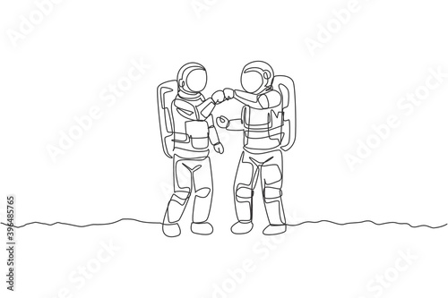 One single line drawing of two young astronauts giving fist bump to celebrate success teamwork in moon surface vector illustration. Cosmonaut outer space concept. Modern continuous line draw design