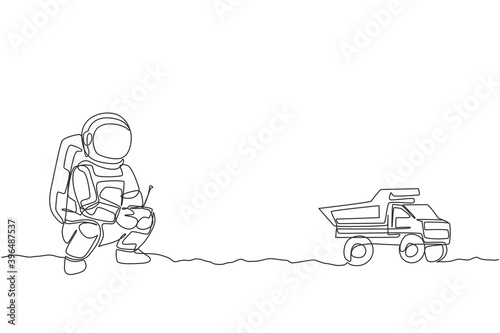 One single line drawing of astronaut playing dump truck radio control in moon land graphic vector illustration. Doing hobby while leisure time in deep space concept. Modern continuous line draw design