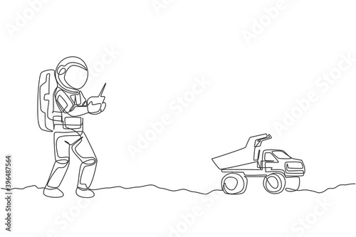 One continuous line drawing of astronaut playing dump truck radio control in moon cosmic galaxy. Outer space hobby and lifestyle concept. Dynamic single line draw design vector illustration graphic