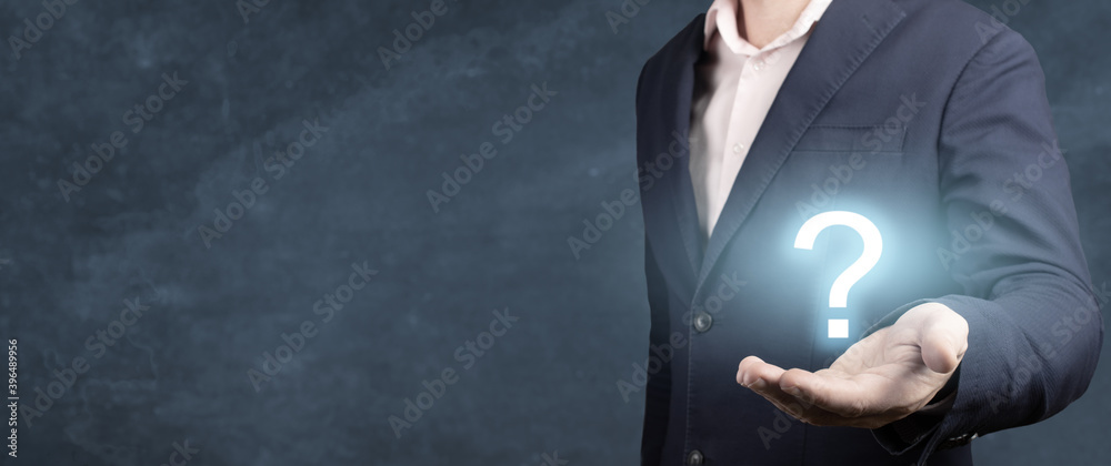 Businessman showing Question mark. man holds a glowing question mark in his hand. banner, blue background - obrazy, fototapety, plakaty 
