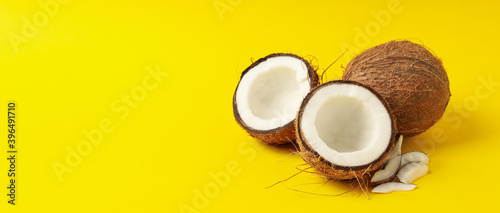 Group of tasty fresh coconut on yellow background