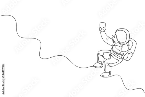 Single continuous line drawing of floating science astronaut in spacewalk pose selfie using smartphone. Fantasy deep space exploration, fiction concept. Trendy one line draw design vector illustration