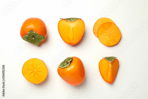 Flat lay with ripe persimmon on white background