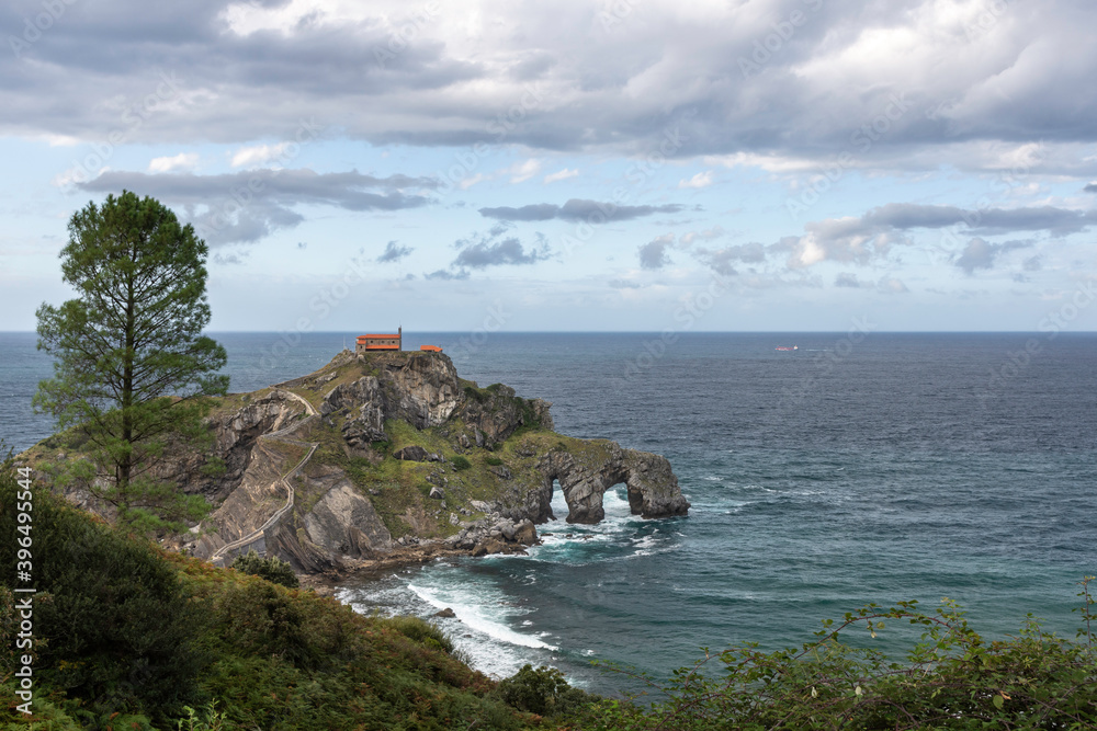 beautiful dramatic and cloudy landscape of a hermitage on a rock mountain within the sea