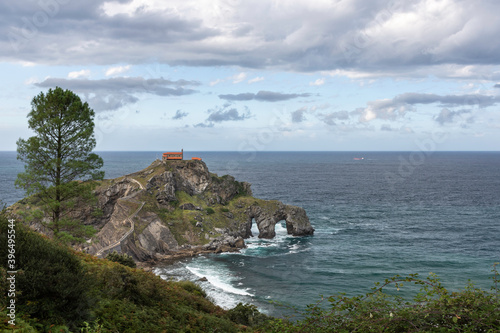 beautiful dramatic and cloudy landscape of a hermitage on a rock mountain within the sea