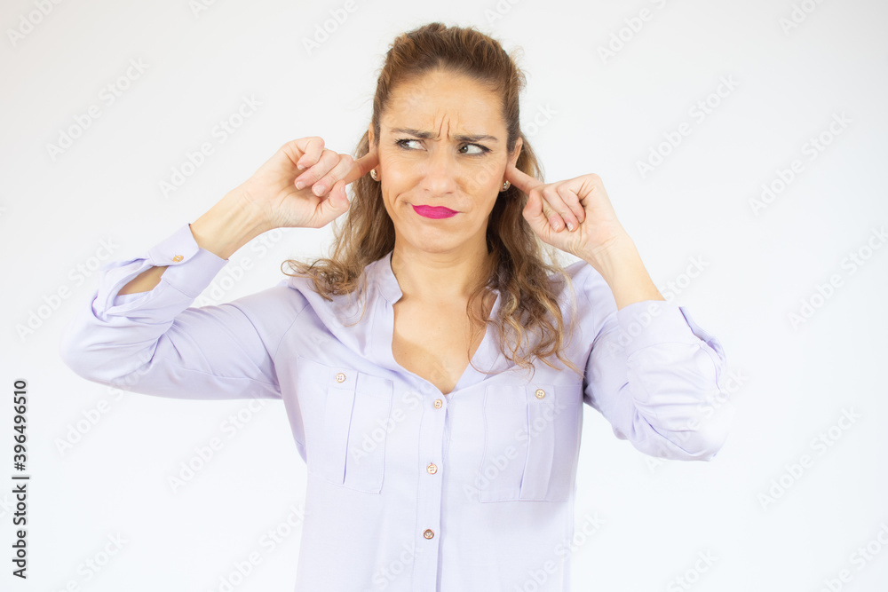 Portrait of a beautiful woman covers her ears isolated over white background Portrait of a beautiful woman covers her ears isolated over white background