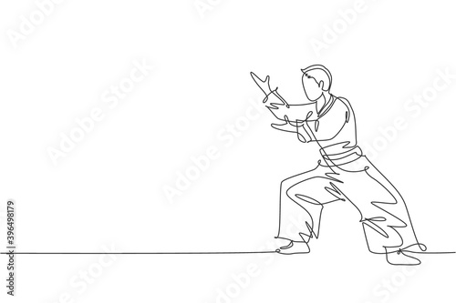 Single continuous line drawing young sportive man wearing kimono practice aikido fighting stance pose technique. Japanese martial art concept. Trendy one line draw design vector illustration graphic