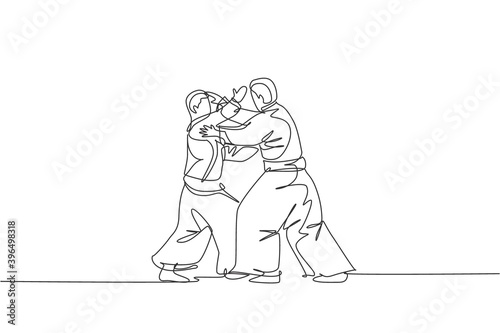 Single continuous line drawing of two young sportive man wearing kimono practice aikido technique woth sparring fight. Japanese martial art concept. Trendy one line draw design vector illustration