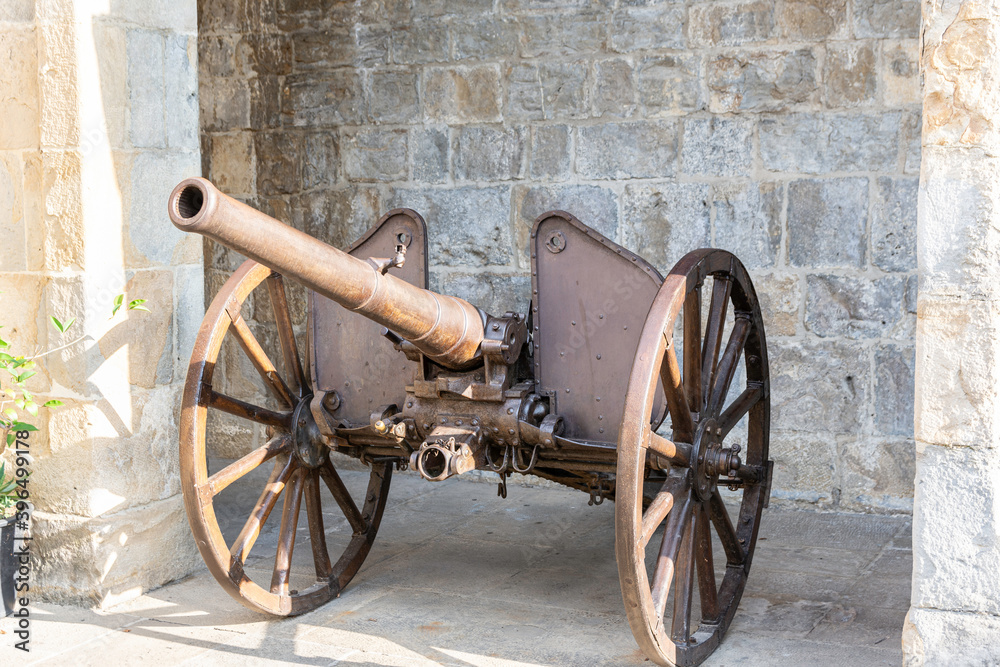 old detailed field cannon of war exposed in the parade ground of a fortress