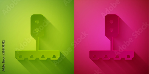 Paper cut Train traffic light icon isolated on green and pink background. Traffic lights for the railway to regulate the movement of trains. Paper art style. Vector.