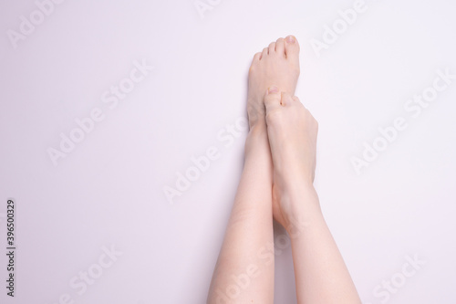 pair of female legs on gray background