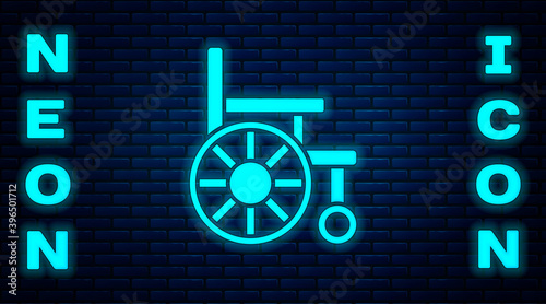 Glowing neon Wheelchair for disabled person icon isolated on brick wall background. Vector.