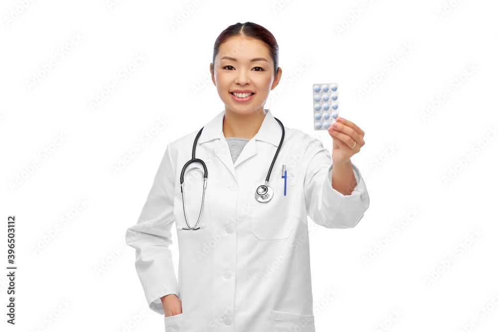 medicine, profession and healthcare concept - happy smiling asian female doctor or nurse with pills over white background medicine, profession and healthcare concept - happy smiling asian female doctor or nurse with pills over white background