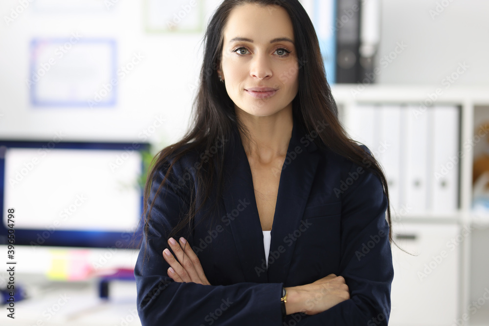 Portrait of young brunette woman in business suit in office Portrait of young brunette woman in business suit in office
